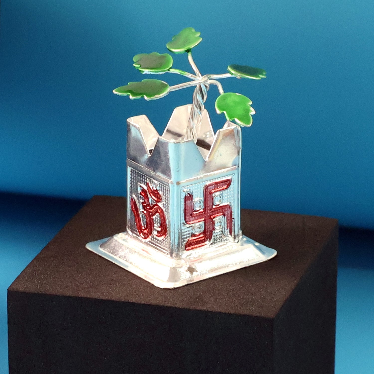 Tulsi Idol placed on a car dashboard, demonstrating its compact size.