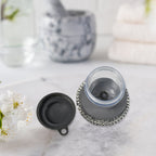 Compact kitchen cleaning brush with an integrated soap dispenser, ideal for small spaces.