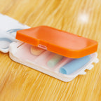 Open dual-sided pill organizer with 8 compartments for tablets and capsules