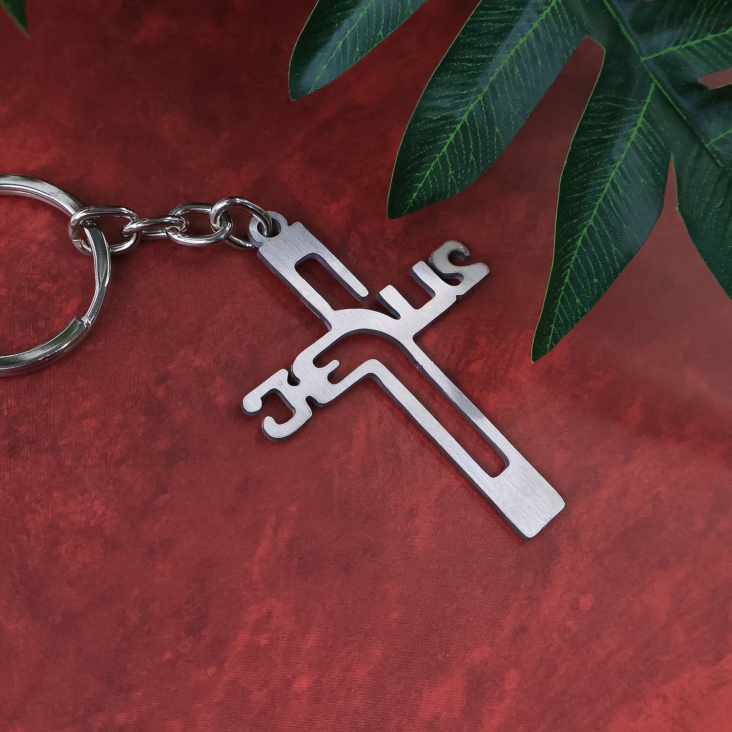 Side view of metal cross keychain with Gujarati Jesus script