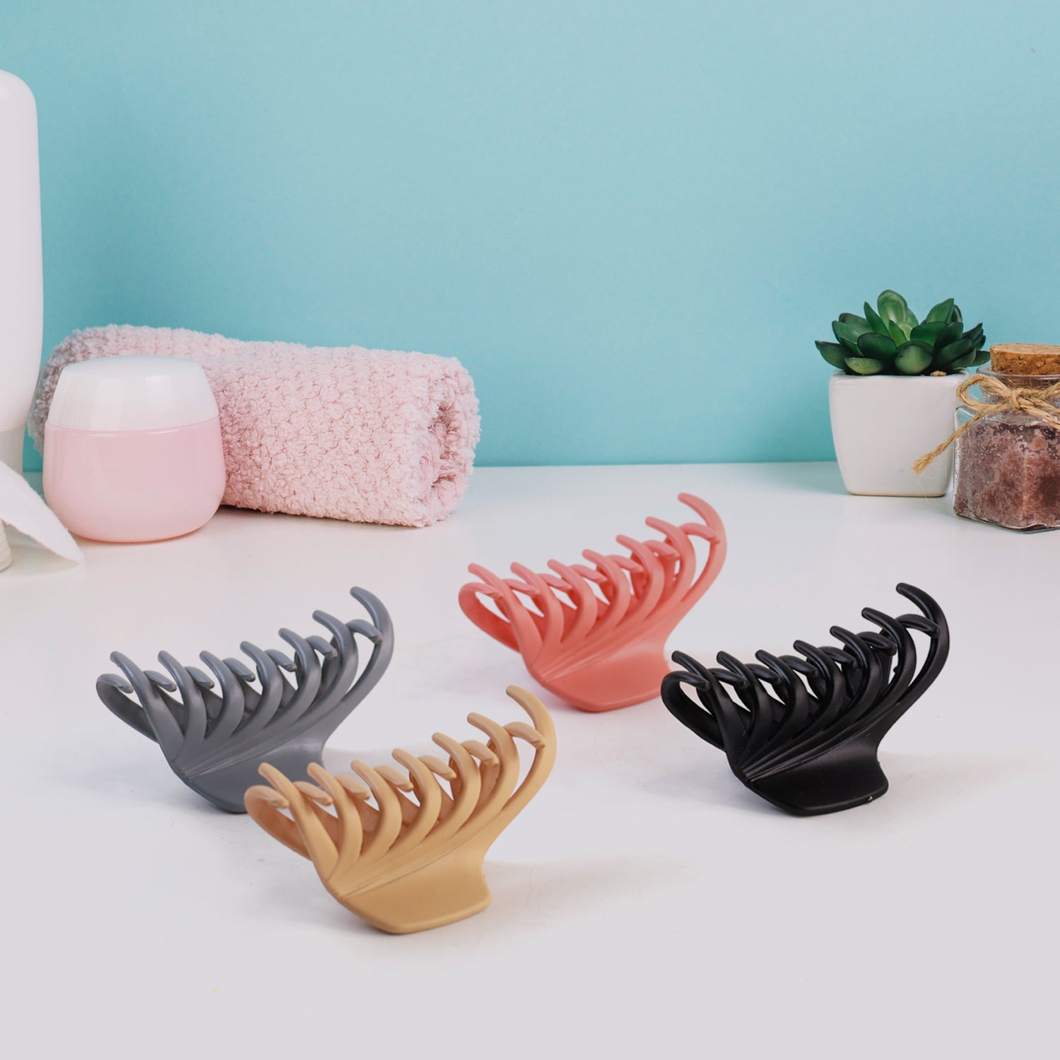 Matte hair claw clip resting on reflective surface