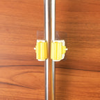 Detailed diagram showing the installation steps for the self-adhesive mop holder.