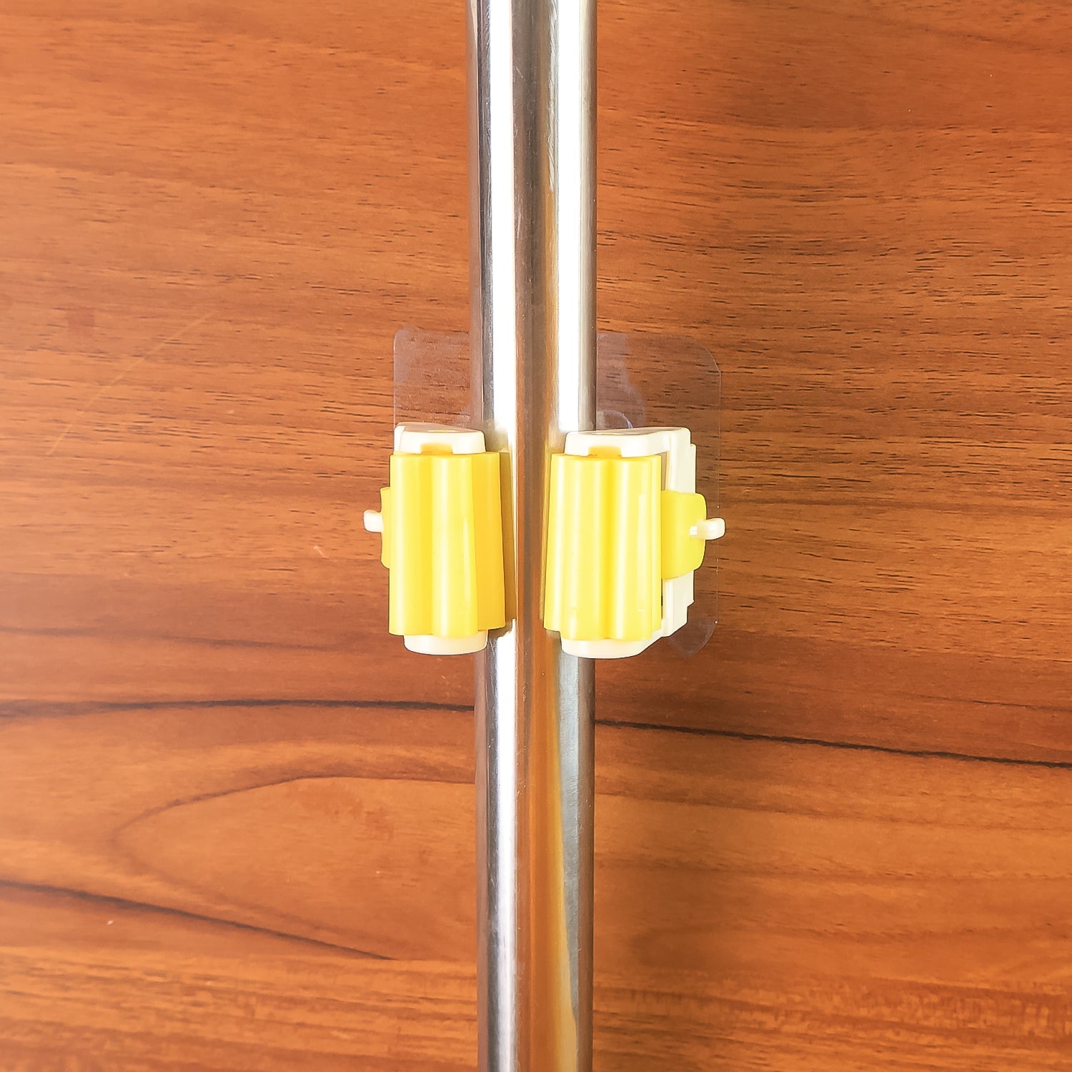 Detailed diagram showing the installation steps for the self-adhesive mop holder.