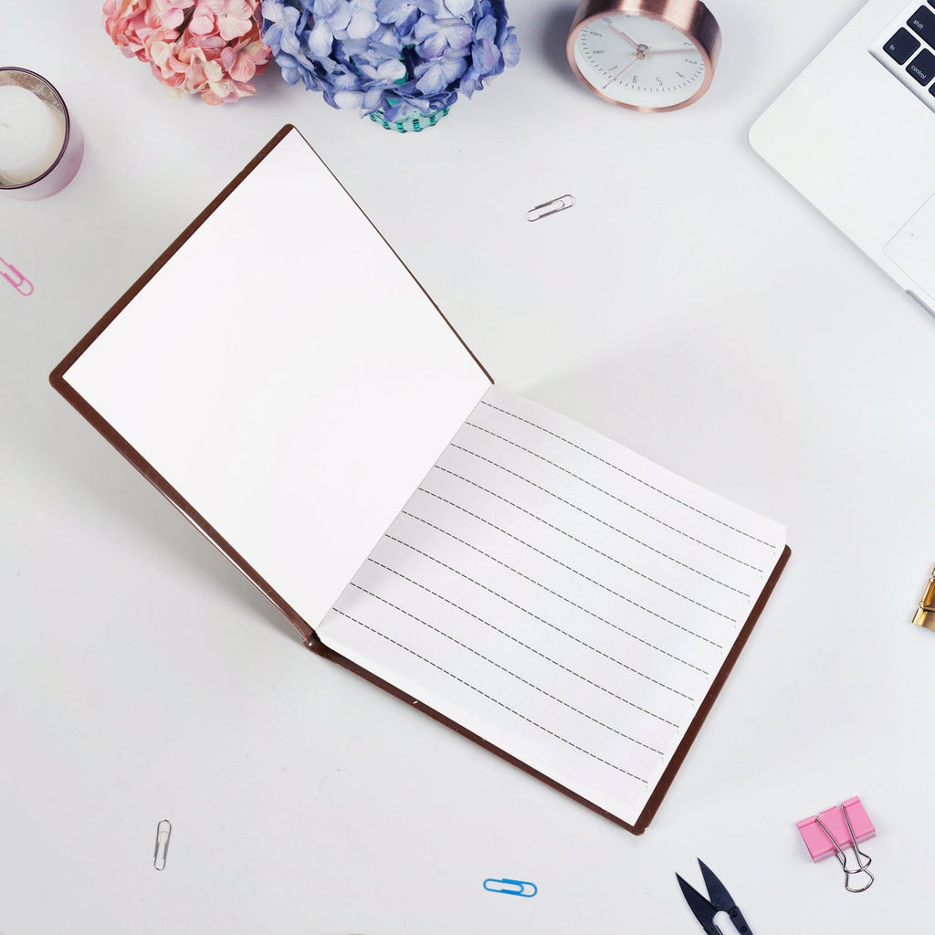 Young child happily writing in a chocolate scented notebook.