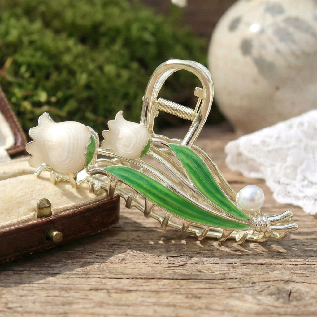 Hair claw clip floral design with pearl accent securing hair