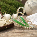 Hair claw clip floral design with pearl accent securing hair