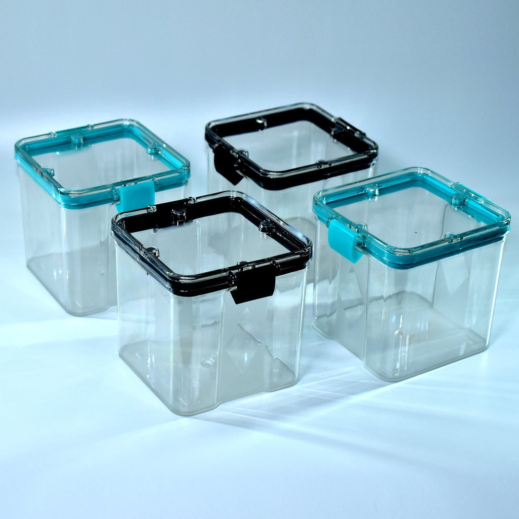 Set of four 700ml square food storage containers on a white background, highlighting their clear design.