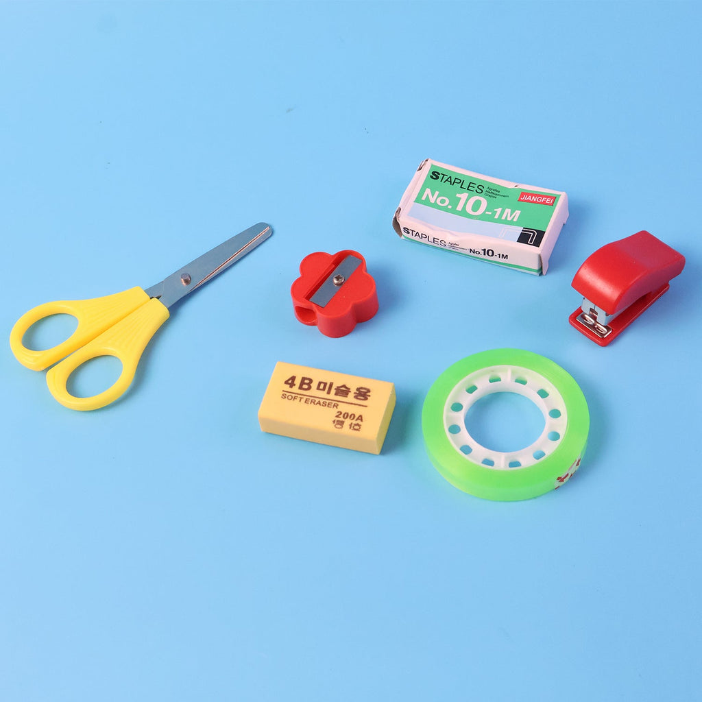 Compact stationery utility kit showing tape dispenser and sharpener tools