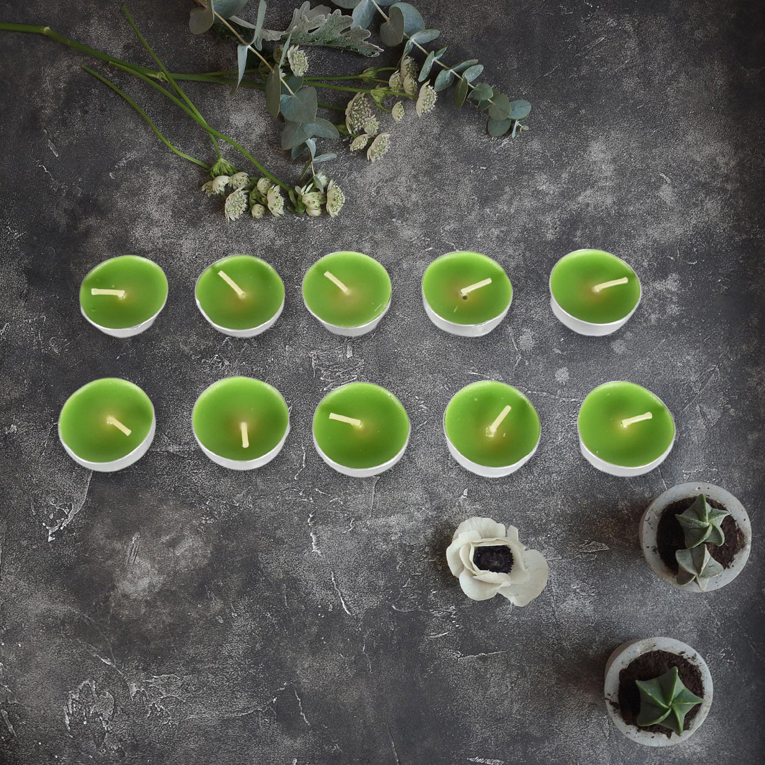 Diwali candles arranged artistically with traditional Indian diyas for home decoration.