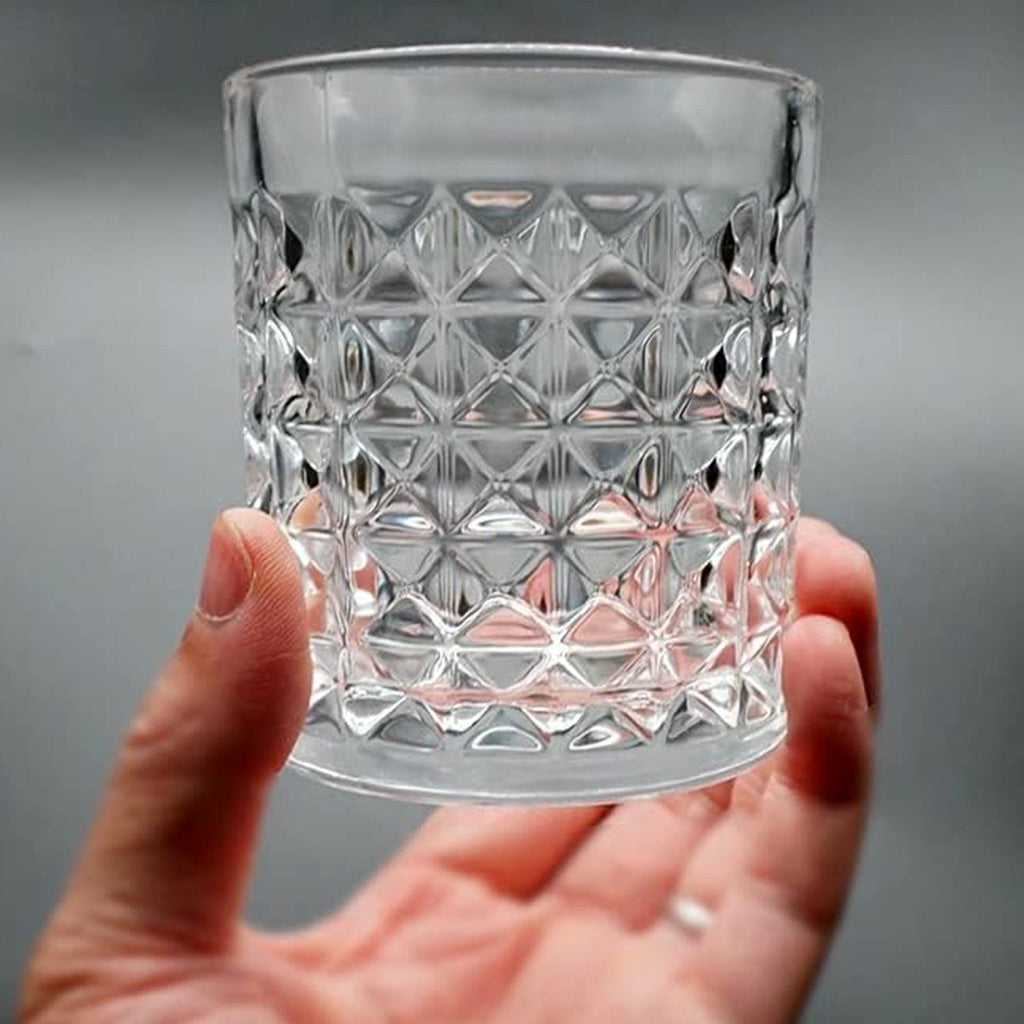 Detailed shot of the base and rim of a diamond-cut glass tumbler, showing its thick and durable construction.