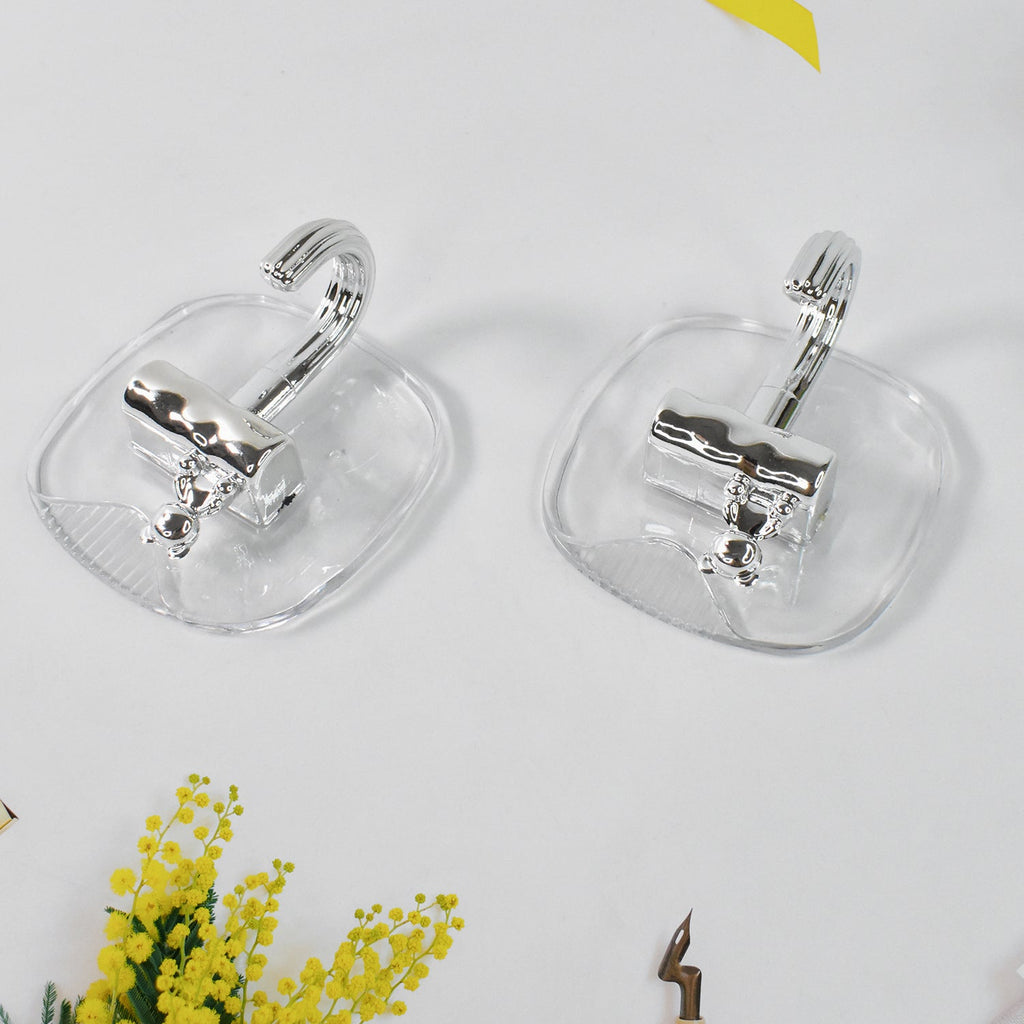 Strong plastic self adhesive wall hooks fixed on kitchen backsplash
