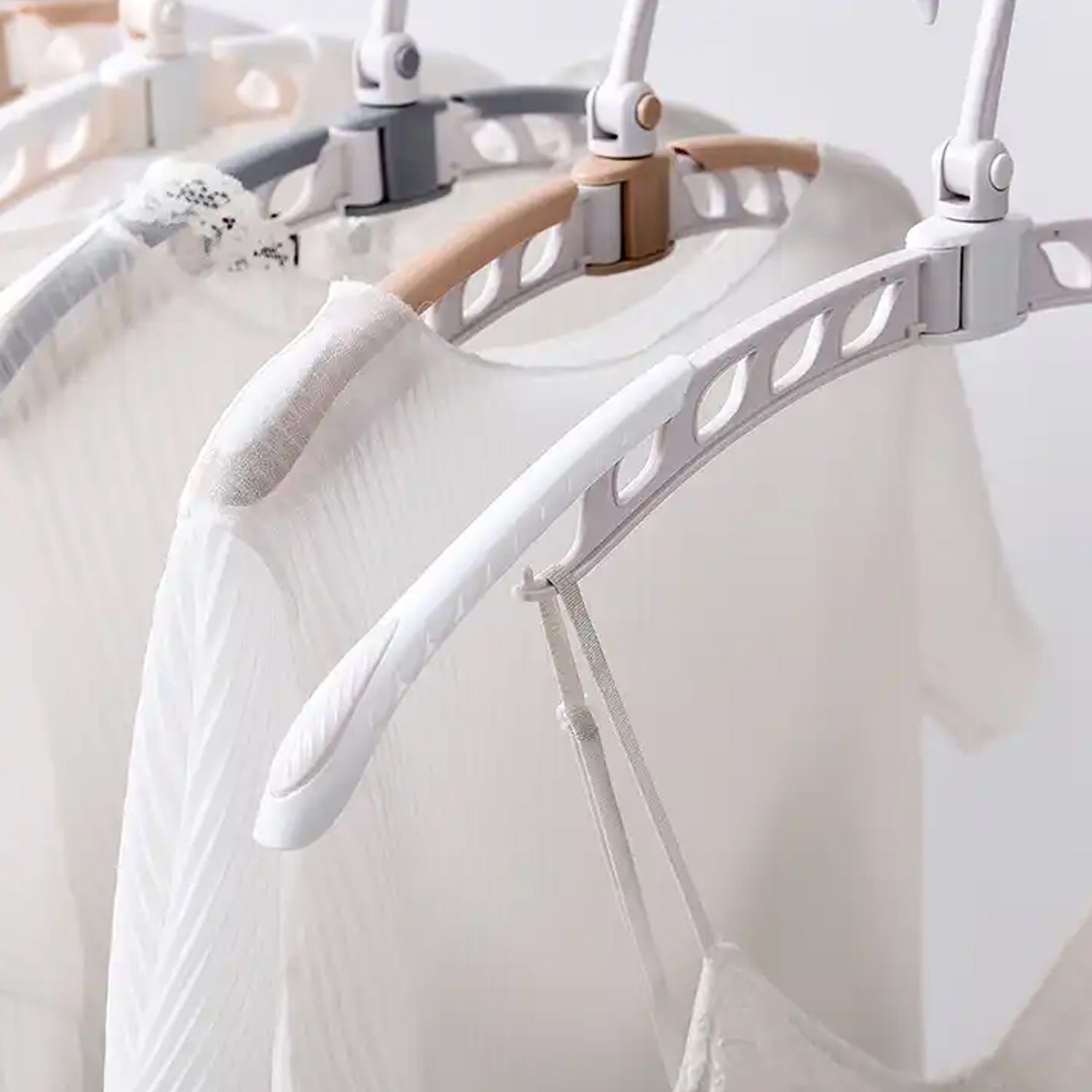Portable folding hanger shown holding various garments.