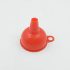 Silicone funnel in action, efficiently pouring oil into a bottle.