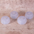 LED tealight candle inside a clear crystal-style holder glowing softly