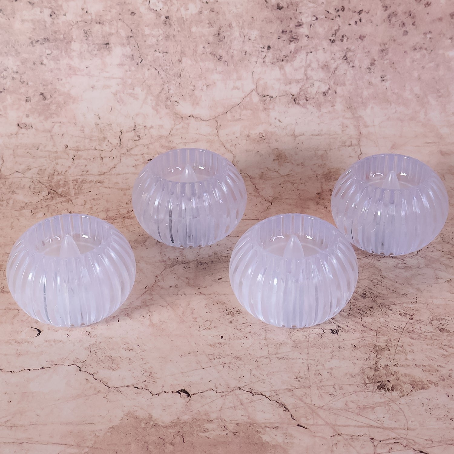 LED tealight candle inside a clear crystal-style holder glowing softly