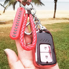 Flat display of anti-lost keychain with red braided strap and number plate