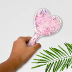 Heart hair brush in a different color, showcasing its compact and travel-friendly size.