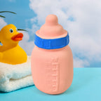 A child's hand gently squeezing the soft rubber baby squeeze toy, demonstrating its sound.