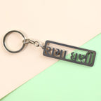 Top view of Gujarati devotional metal keychain with key holding ring