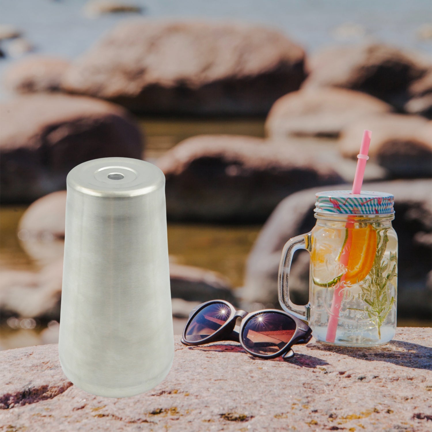 Elegant stainless steel mug resting on a rustic wooden surface.