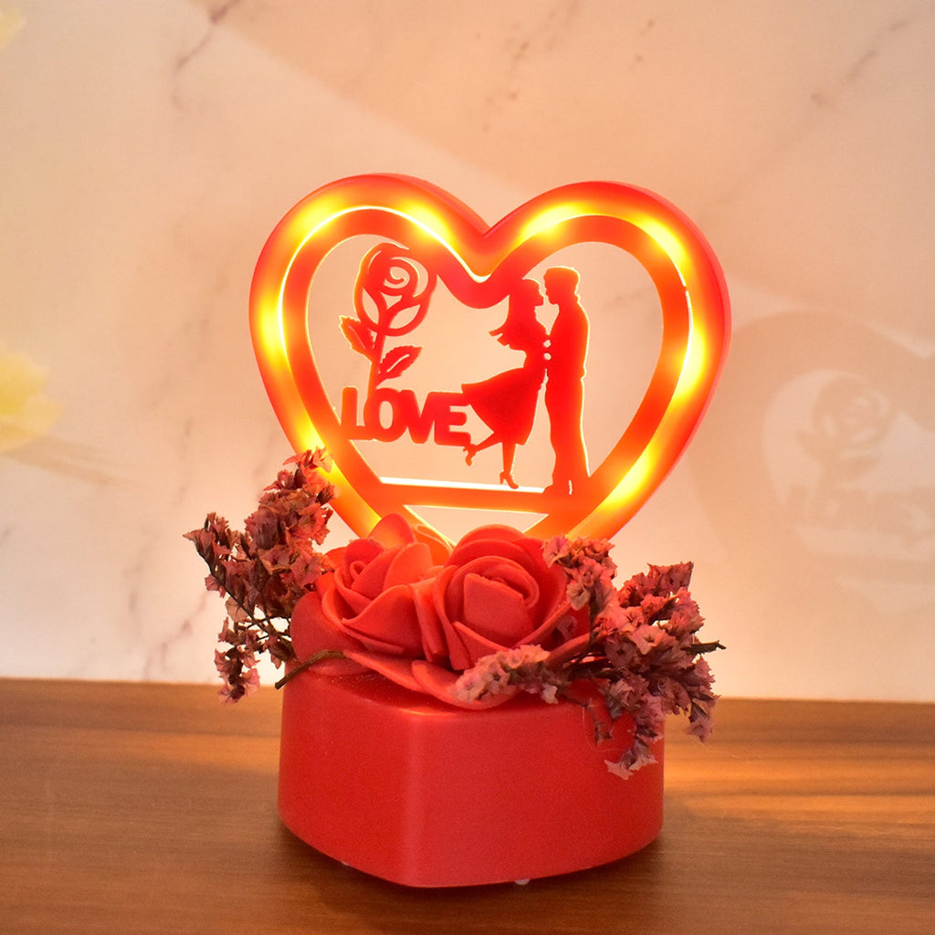 Close-up of heart-shaped love couple ornament with rose base