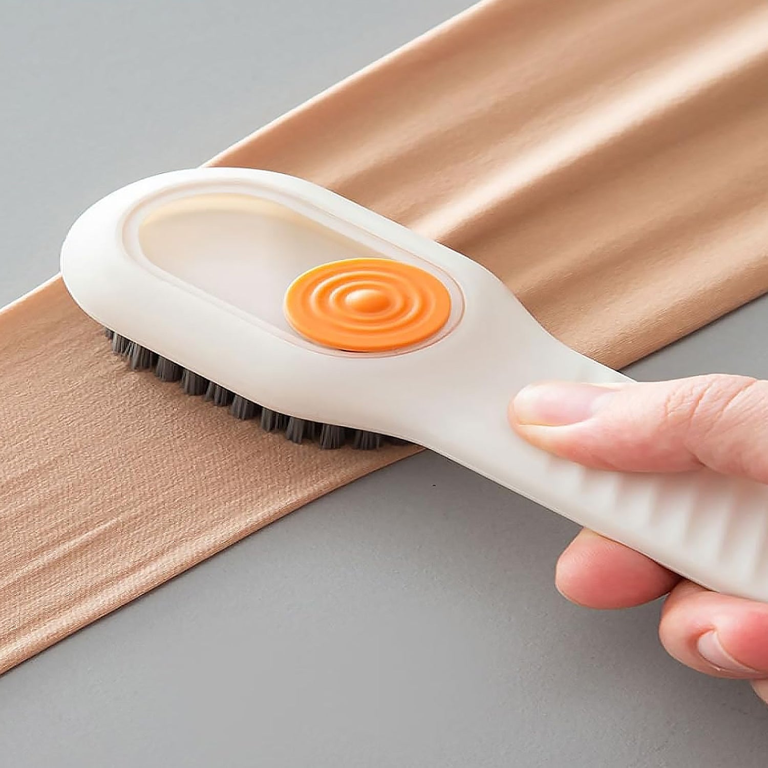 Liquid dispensing brush effectively cleaning a pair of shoes.