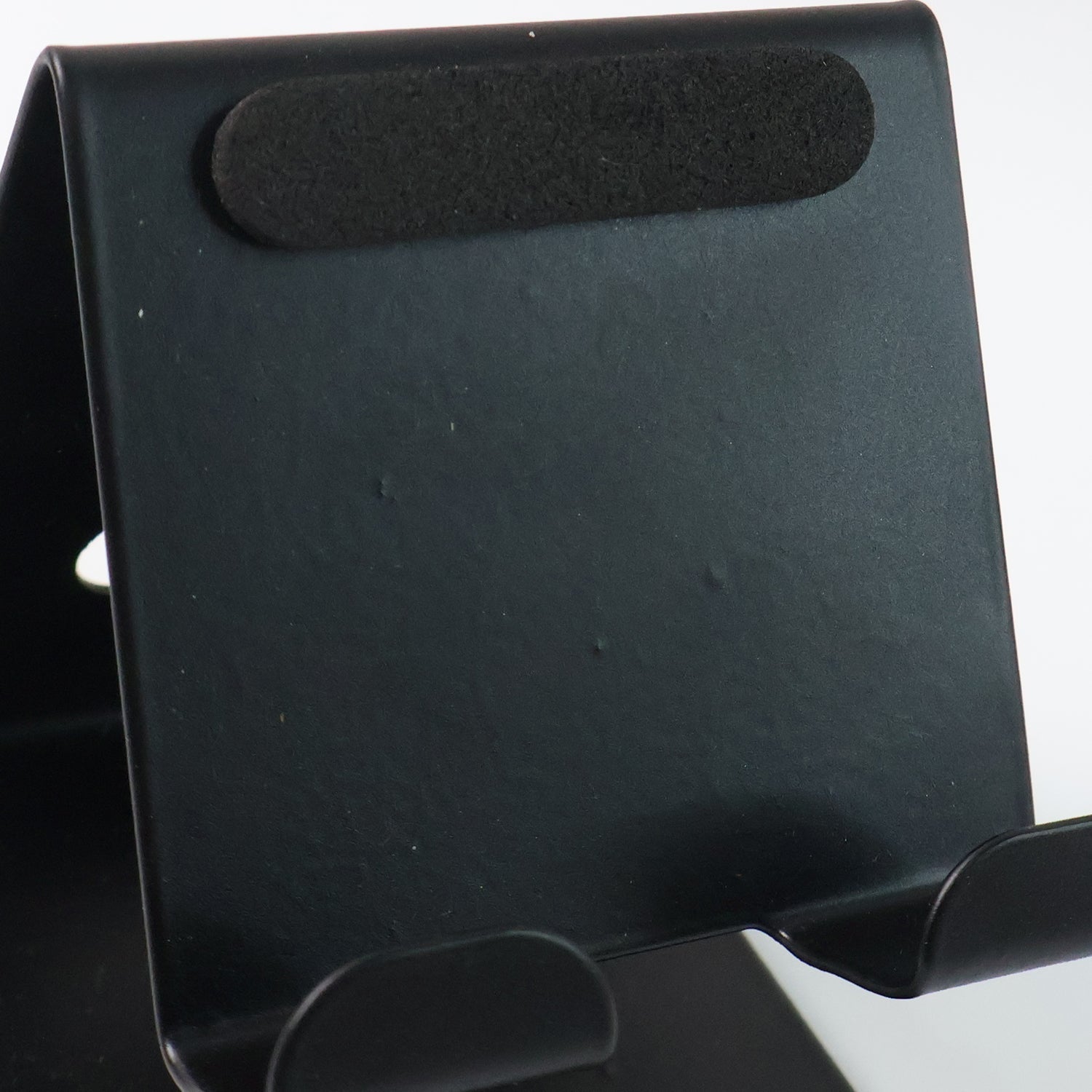 Front view of metal mobile and tablet stand showcasing compact and portable design