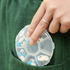 7-sided portable pill box with clear lids showing organized daily compartments