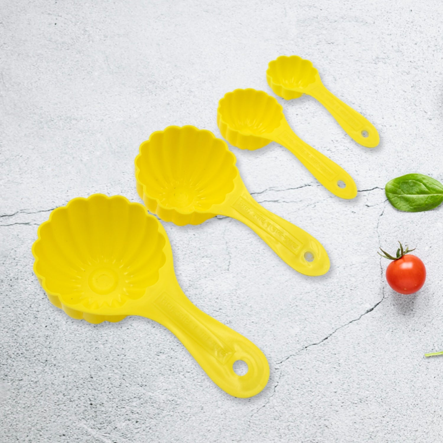 The complete set of four plastic ladoo making spoons, ideal for crafting various traditional sweets.