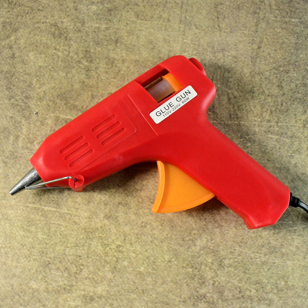 Craftily hot melt glue gun being used to bond various materials.