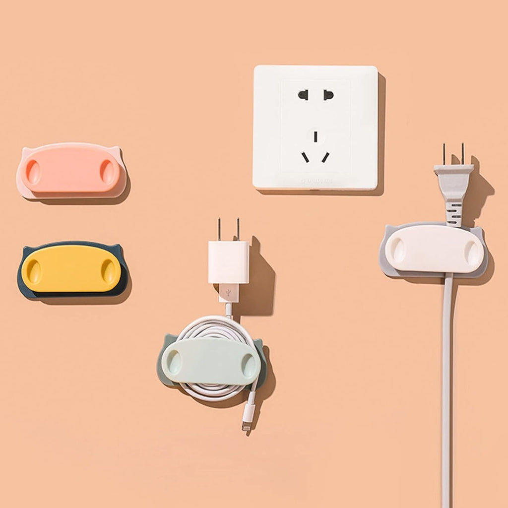 Wire organizer clips holding charging cables with adhesive pad