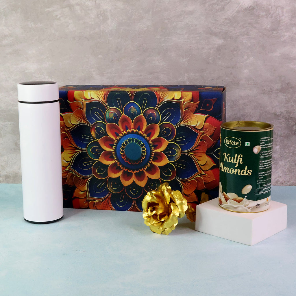 Elegant gift hamper featuring kulfi almonds chocolate with golden decorative rose and metal bottle