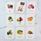 Flashcards arranged on table showing bright and realistic fruit images