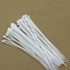 Close-up of 6-inch black nylon self-locking cable ties in a pack of 100.