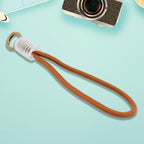 Person's hand securely holding a smartphone with the attached multicolor phone lanyard.