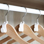 Multiple hanger connector hooks linking clothes hangers in a neat arrangement.