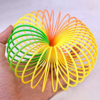 The Rainbow Slinky Toy in its compact, coiled form, displaying its mesmerizing colours.