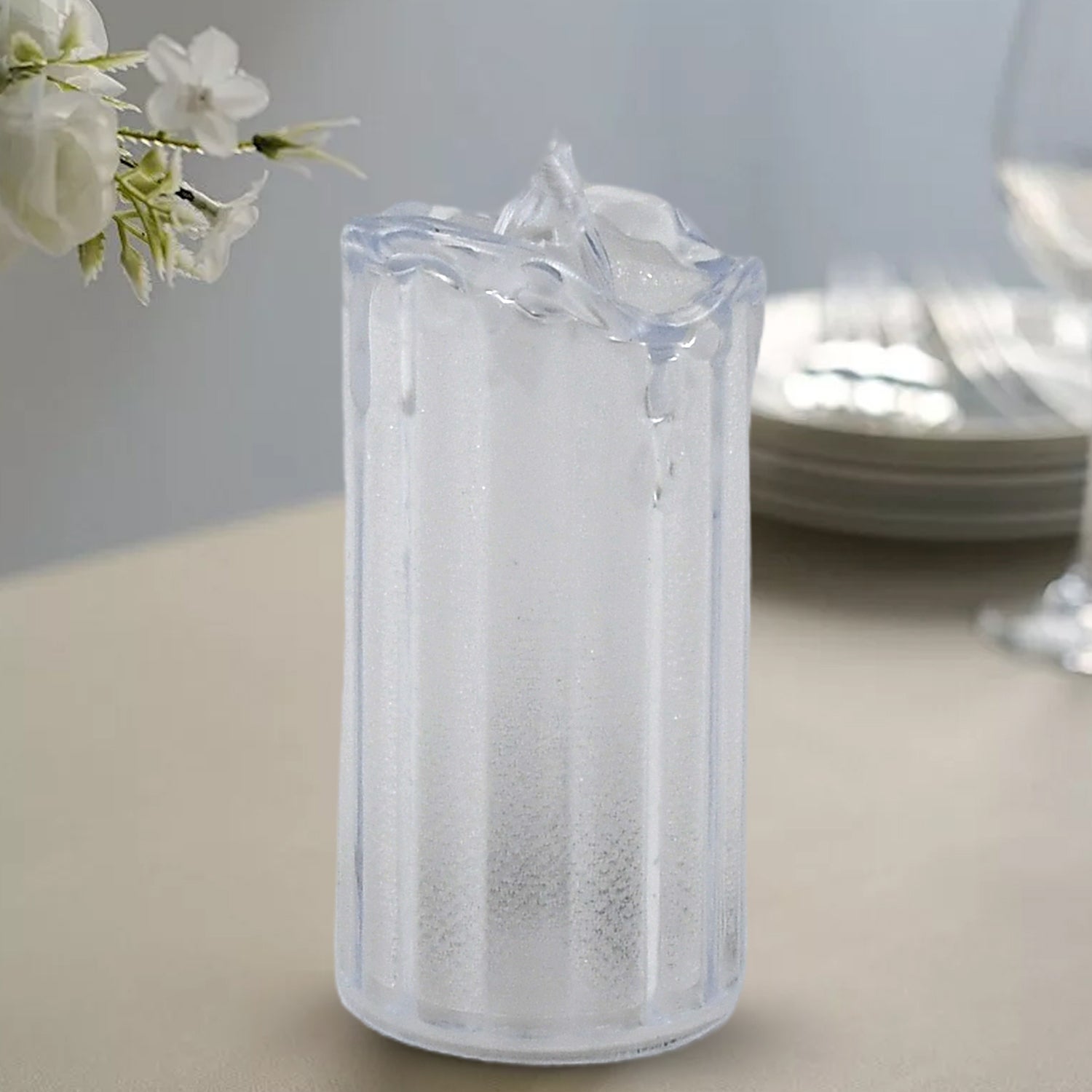 Close-up of a single flameless LED candle showing its realistic flickering glow.