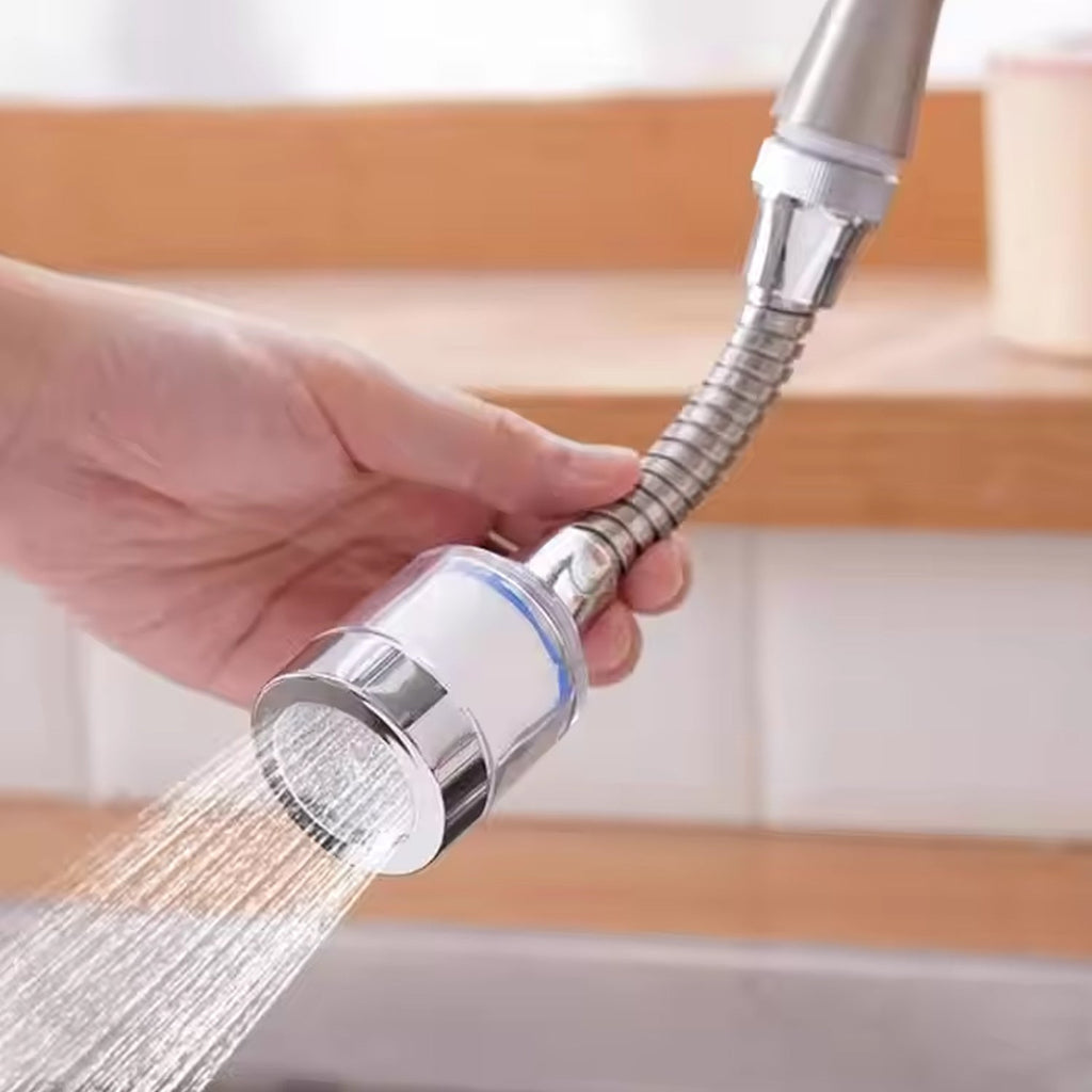 Water-saving faucet sprinkler attached to a kitchen sink, demonstrating flexible water flow.