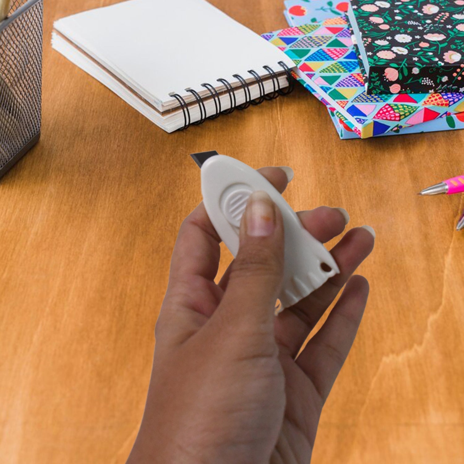 Mini Cloud Box Cutter held in hand for size reference