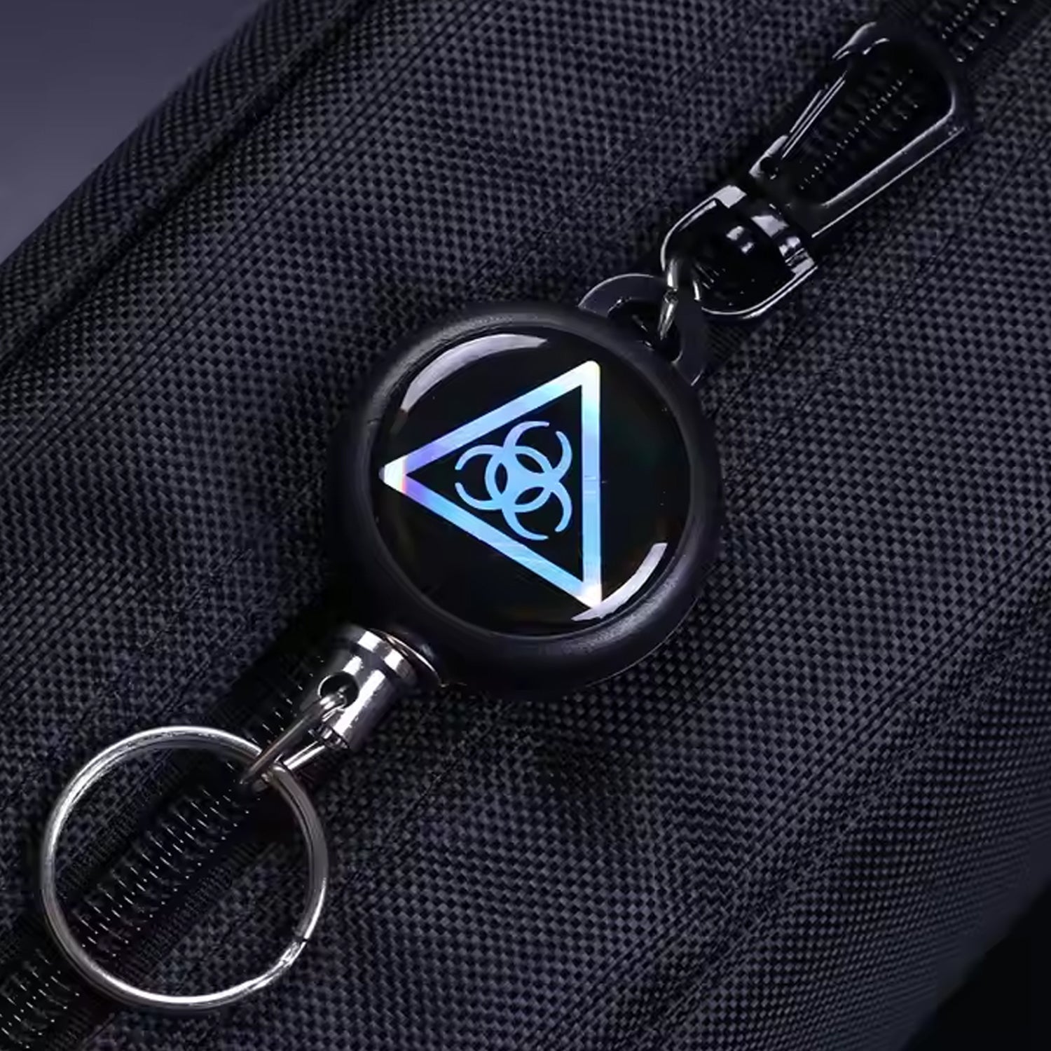 Retractor key chain with steel cable, showcasing its robust build quality.