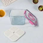 Clear plastic food storage box filled with fresh vegetables.