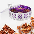 Elegant round silver dry fruit box with four compartments, perfect for serving.
