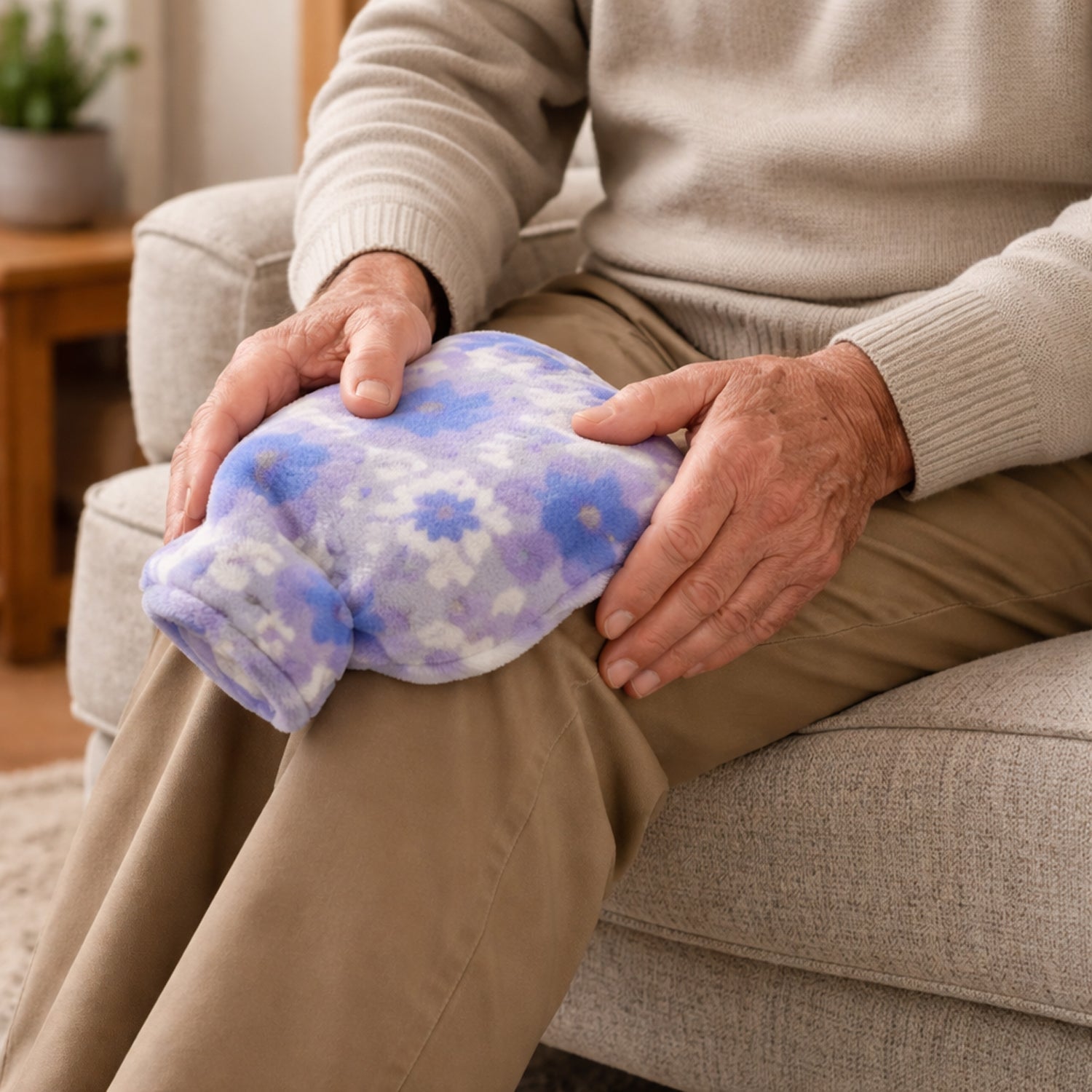 Heat therapy hot water bag featuring plush cover with floral print design