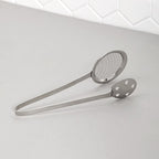 Polished steel serving tong with dual mesh and perforated sides for draining food
