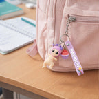 Close-up of doll charm on colourful rainbow strap keychain
