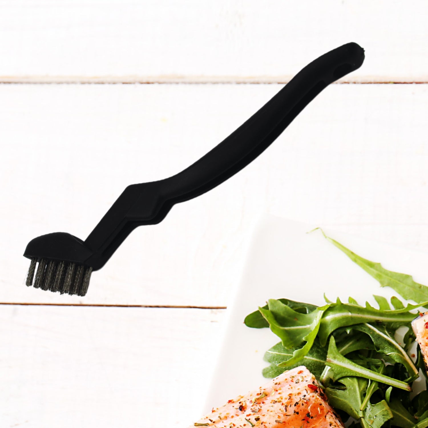Multifunction basting brushes resting on a clean kitchen countertop.