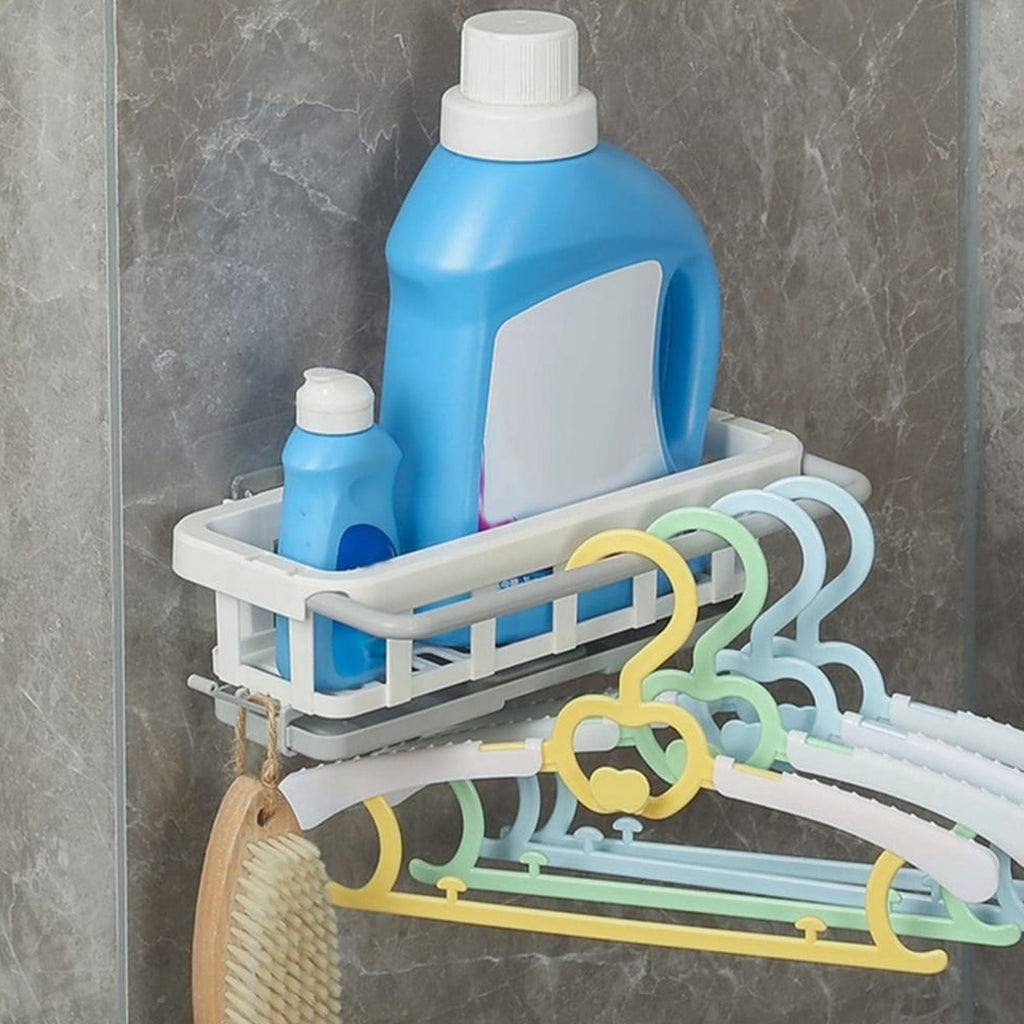 Close-up of a sponge and brush neatly stored in the hanging kitchen sink organizer.