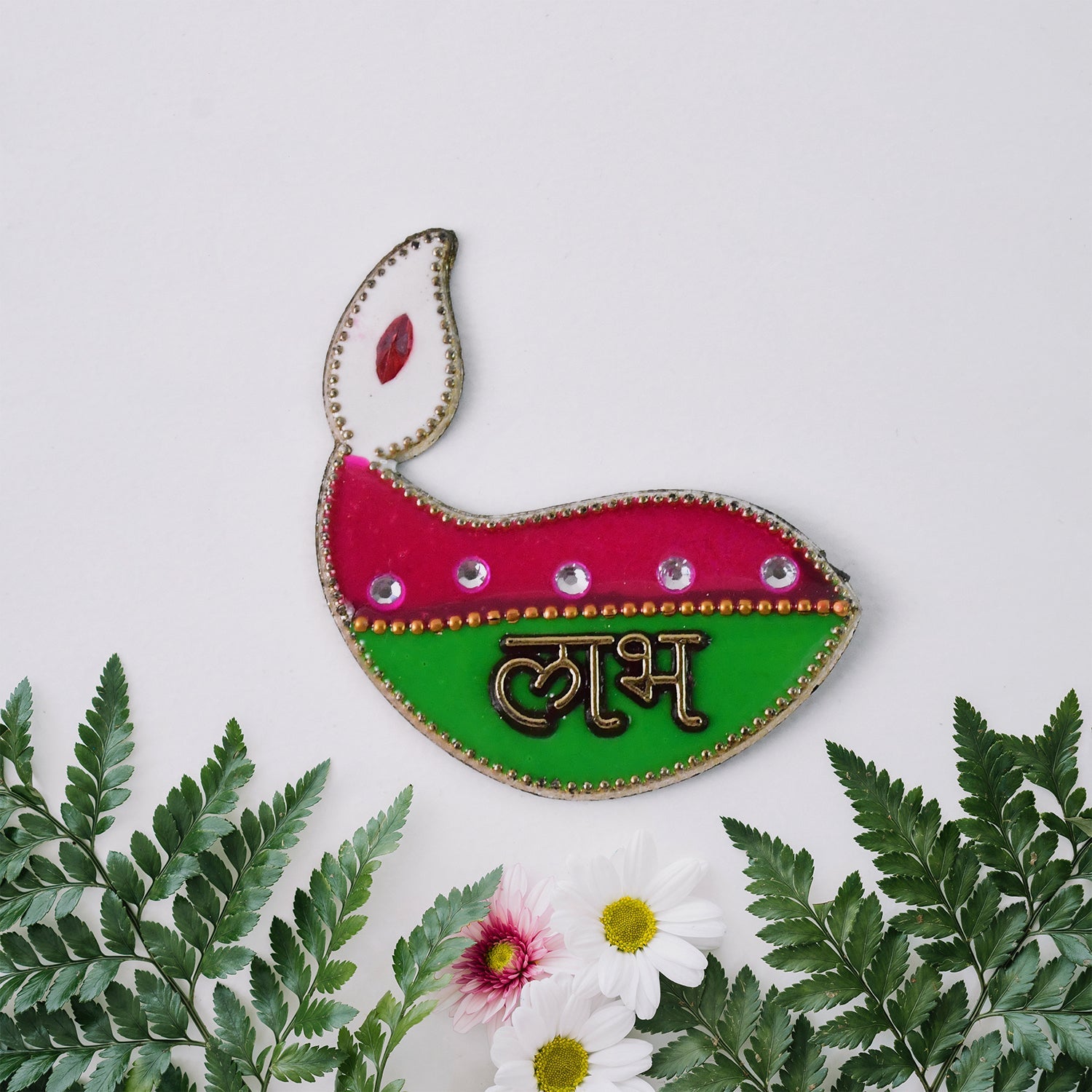 Close-up of diya shaped Shubh Labh wall hangings with golden borders and vibrant colors