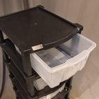 Close-up of flexible clear organizer drawers in plastic storage cabinet